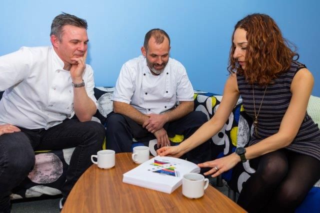 two chefs having a discussion with an agency manager