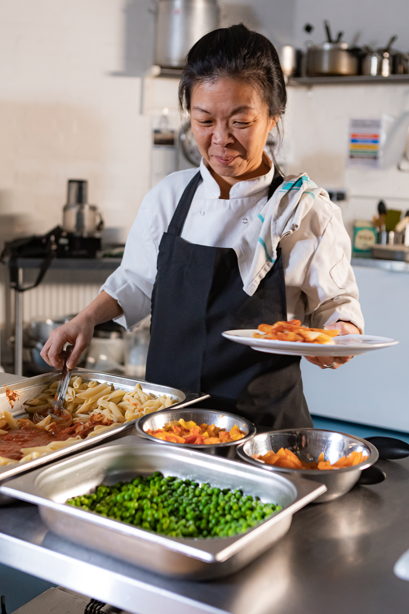 A chef frying food in a wok
