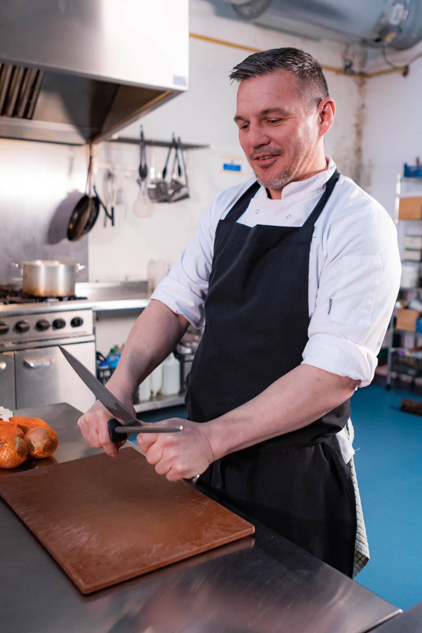 A chef frying food in a wok
